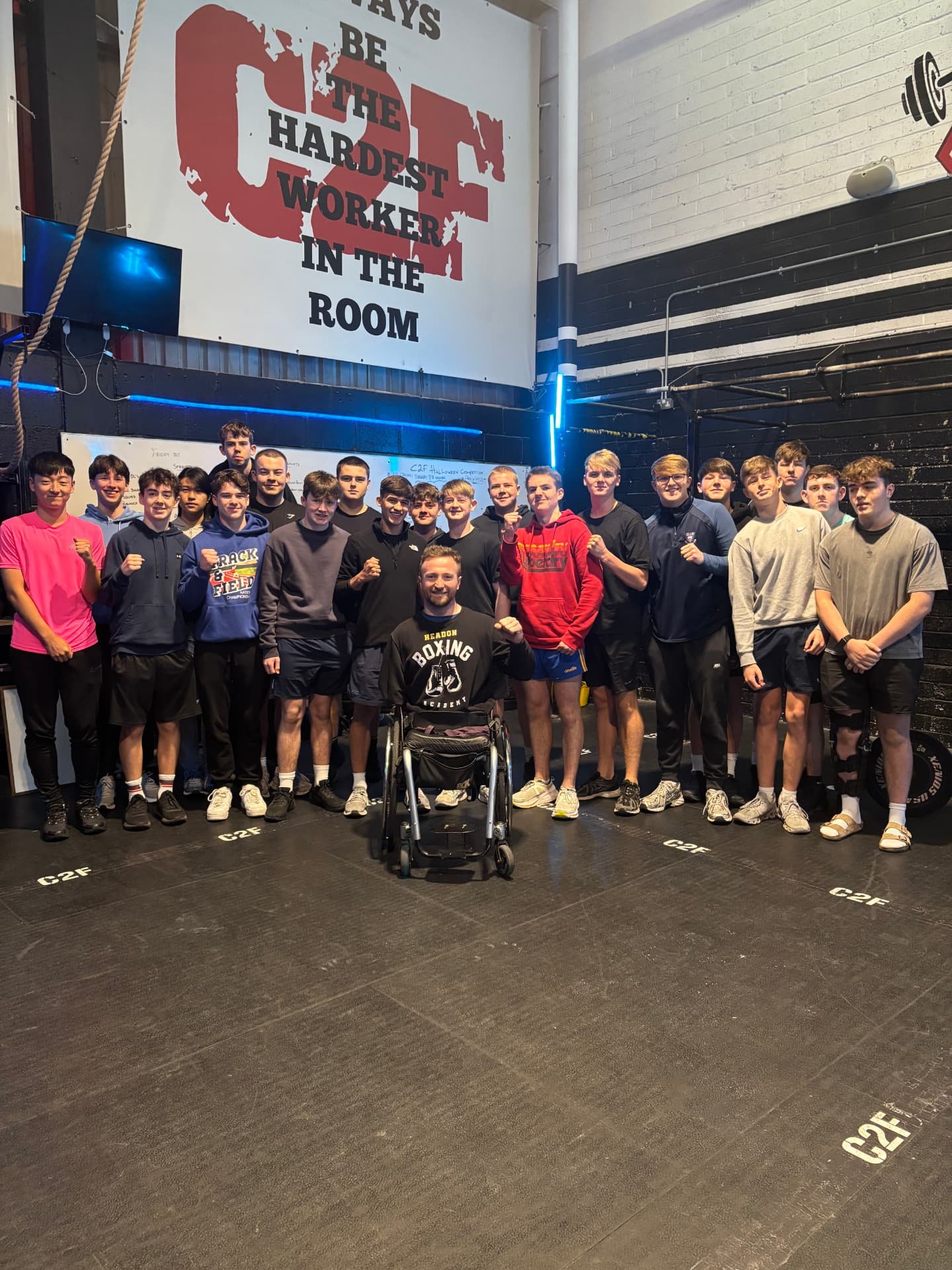 Colin Judge with a school sports group in a gym