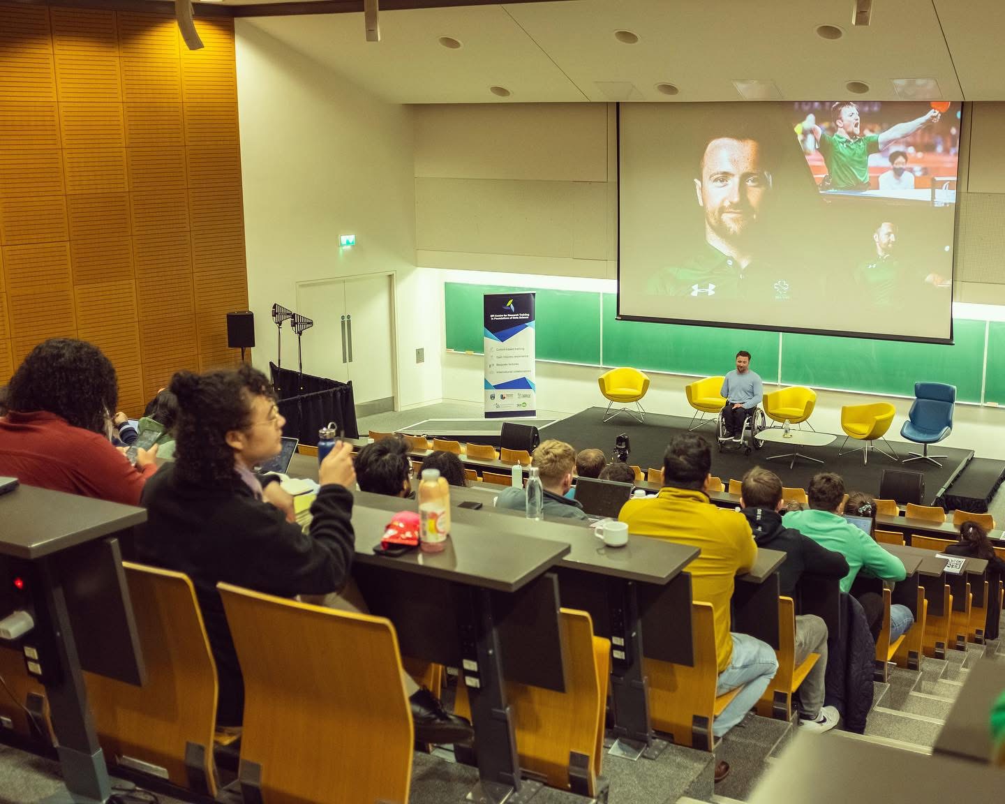 Colin Judge speaking to a packed university lecture hall