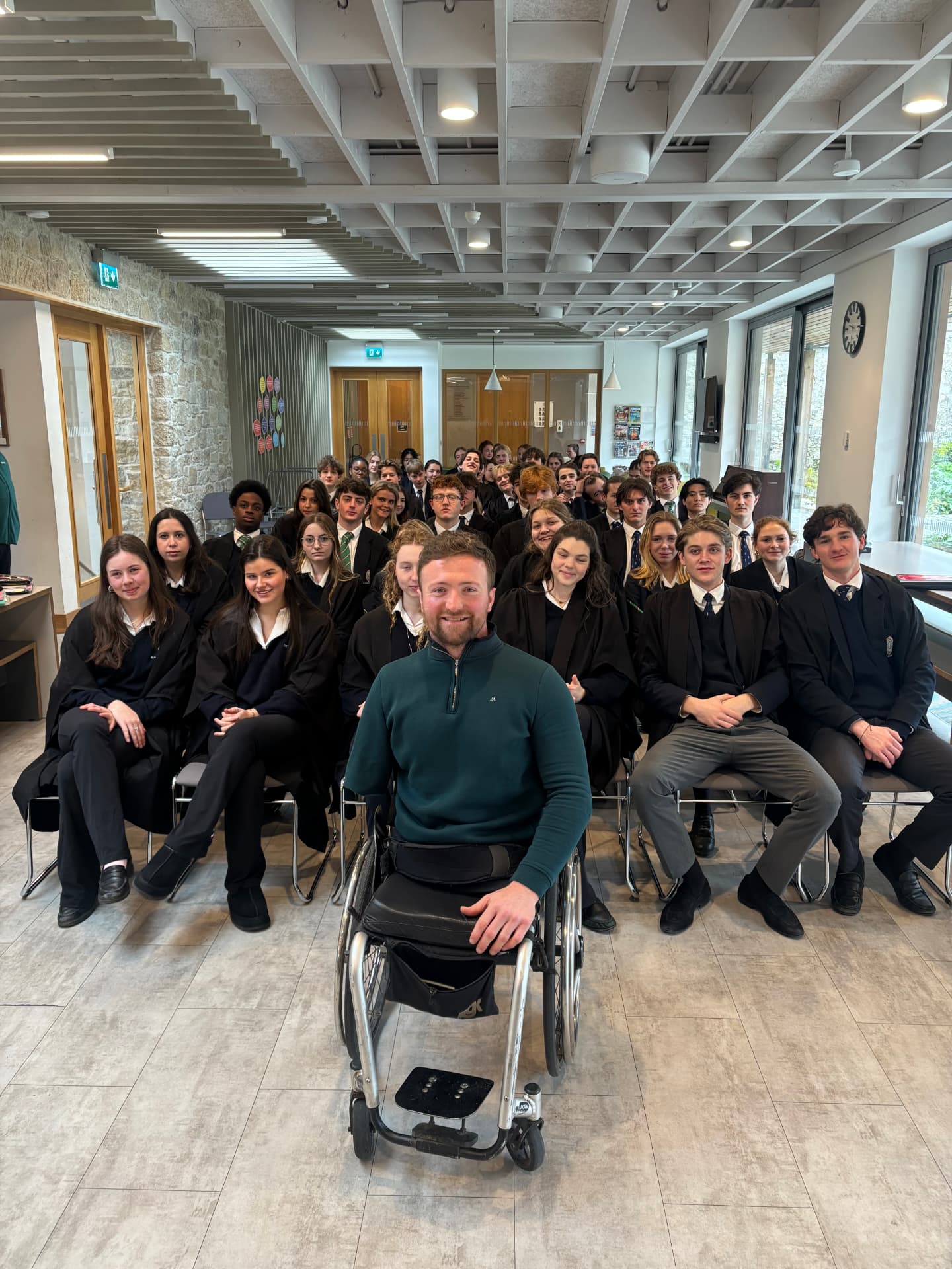 Colin Judge with a group of secondary school students after a talk